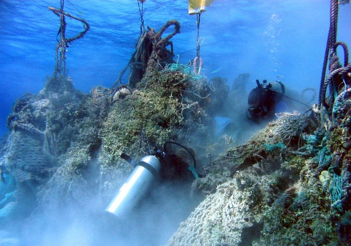 A SCUBA diver helping to free ghost nets from the sea floor so they can be lifted to the surface
