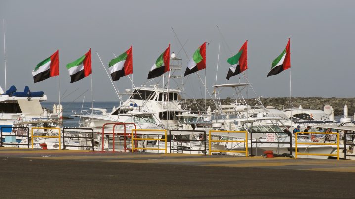 A view of Fujairah sportfishing marina with charter boats and 7 United Arab Emirates flags