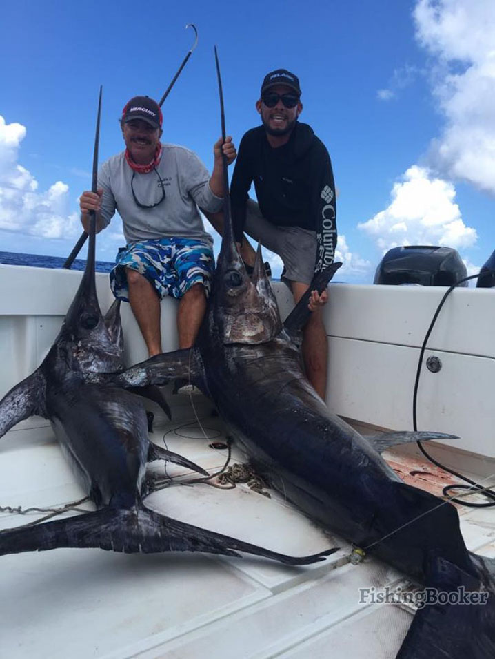 Two anglers with two Swordfish caught on their fishing trip in Miami