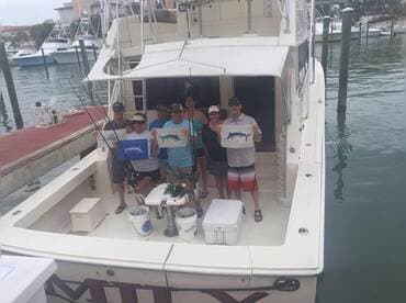 Our clients with their flags: two blue marlin, a white marlin, and a sailfish!