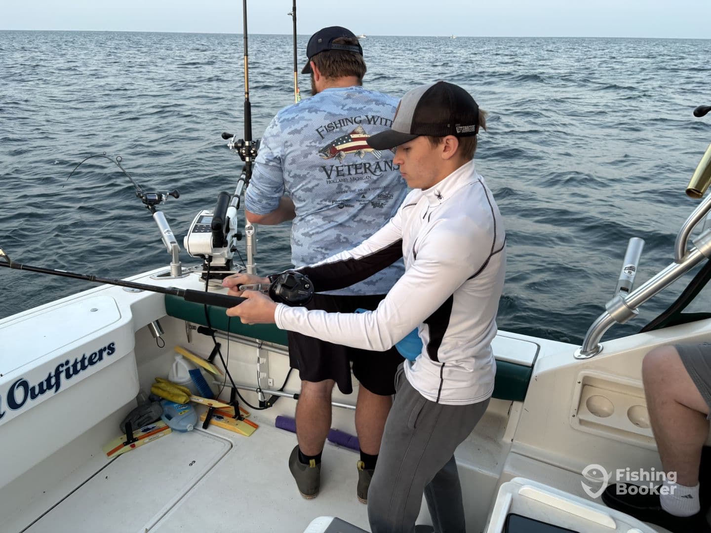A young angler focused on reeling in a catch while fishing aboard a charter boat, showcasing an engaging fishing experience.