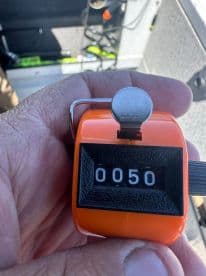 A close-up of a fishing counter displaying the number 50, likely used for tracking catches during a fishing trip.