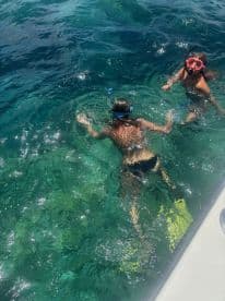 Two young snorkelers exploring the clear waters, showcasing a fun aquatic adventure.