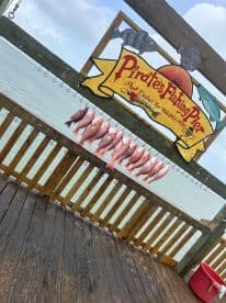 A display of freshly caught Red Snapper hanging on a board at Pirates Fishing Pier, showcasing a successful fishing outing.