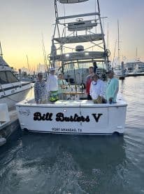 Group of anglers aboard the 'Bill Busters V' boat at Port Aransas, TX, ready for a fishing adventure.