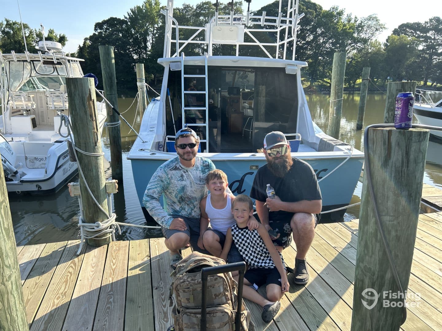 A family poses on the dock beside a blue fishing boat, showcasing a fun day out on the water.