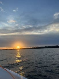 A scenic sunset view over the water, capturing the tranquil atmosphere of a fishing trip.