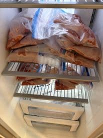 Frozen fish fillets stored in zip-lock bags, ready for future meals, showcasing proper storage techniques.