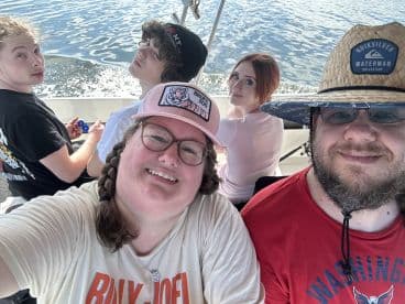 A group of friends enjoying a day on the water, capturing a fun moment inside the boat with smiles and laughter.