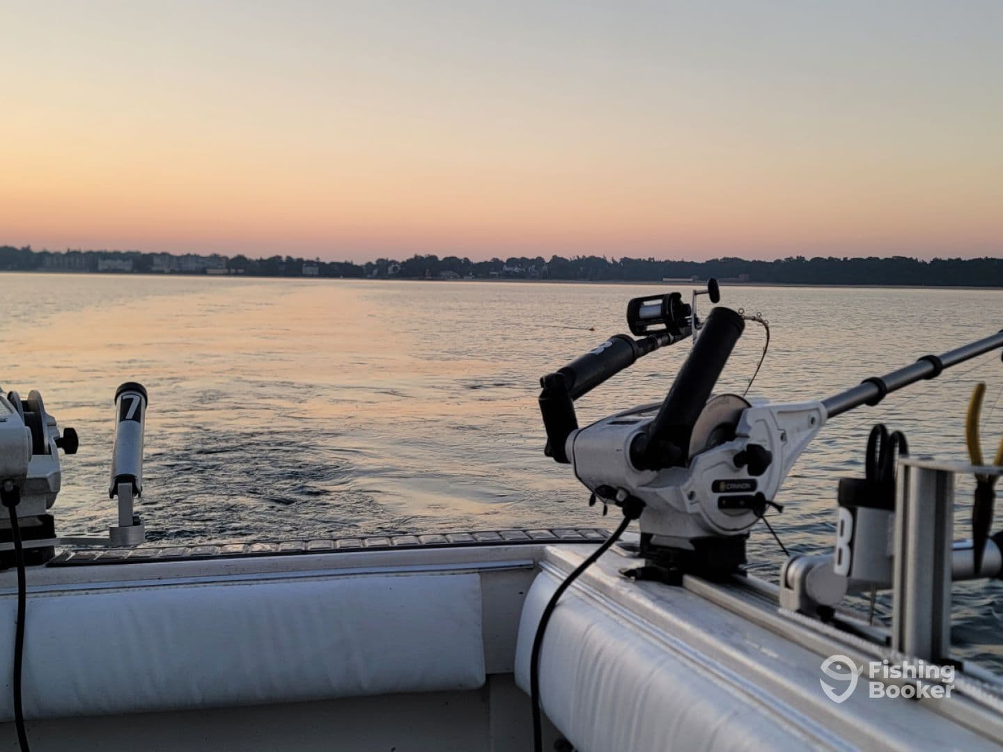 A serene view from the interior of a fishing boat at dawn, showcasing the fishing gear and calm waters.