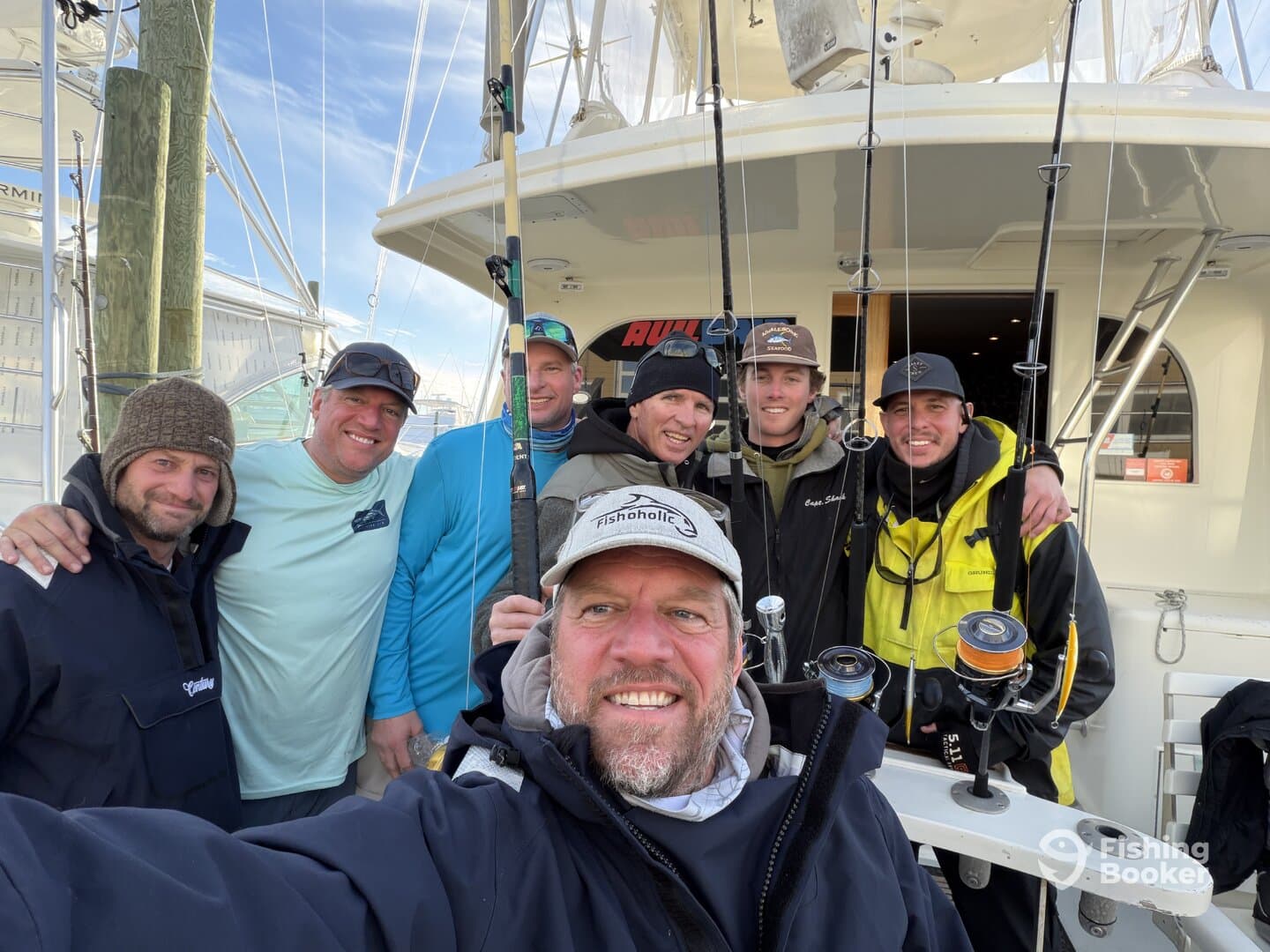 Group of anglers posing together on a fishing boat, showcasing camaraderie before heading out for a fishing adventure.