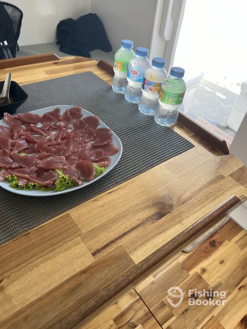 Freshly prepared sashimi displayed on a plate, showcasing the catch of the day aboard a fishing charter.