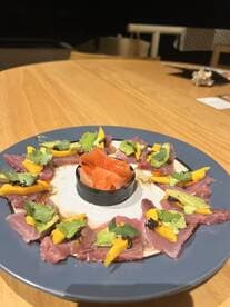 A beautifully arranged plate of sashimi featuring various garnishes, showcasing a culinary presentation rather than a fishing catch.