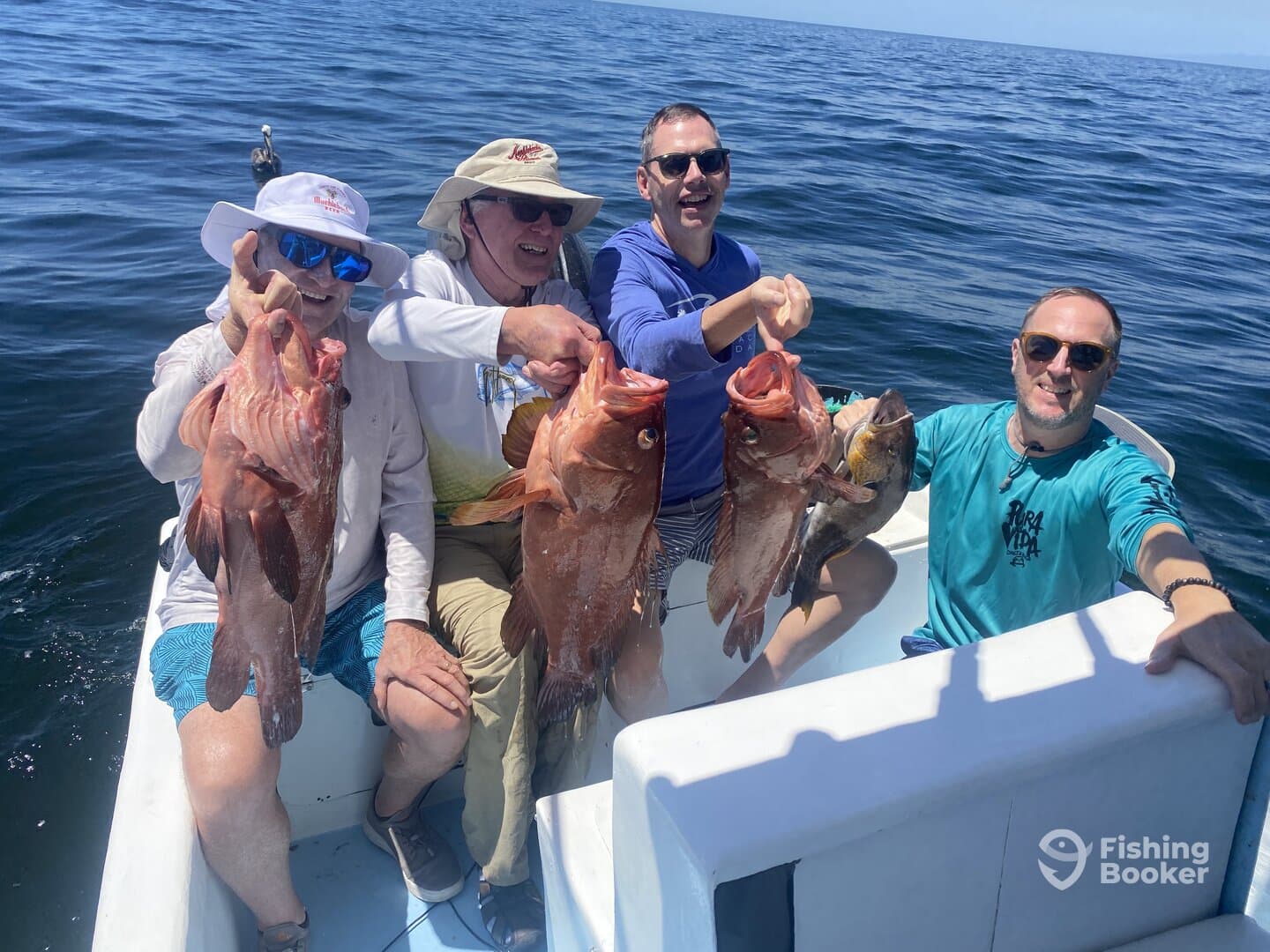 Group of anglers proudly displaying their catch of Red Snapper while enjoying a day on the water.