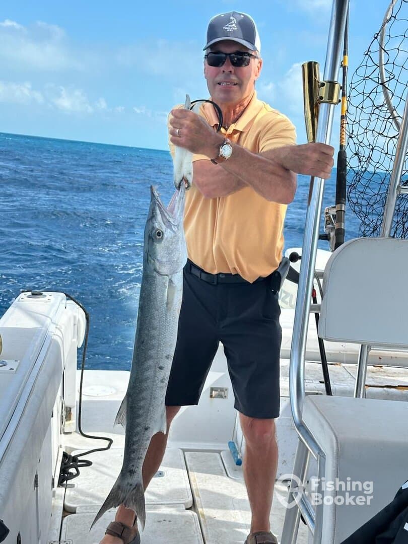 Angler proudly displaying a large fish while fishing on a boat in open waters.