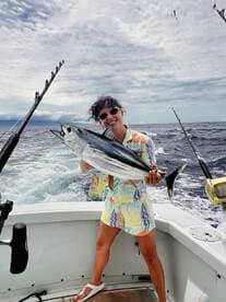 Angler proudly displaying a large fish while aboard a boat, showcasing a vibrant fishing environment.