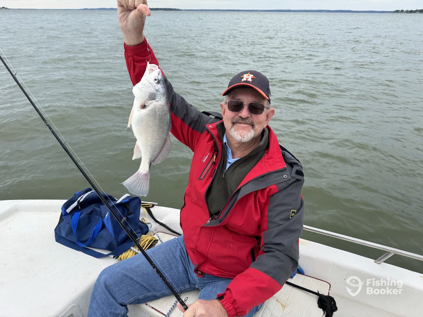An angler proudly displaying a freshly caught fish while enjoying a day on the water.