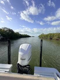 A scenic view from the front of a boat navigating through a mangrove-lined waterway, showcasing the Yamaha 300 outboard motor.
