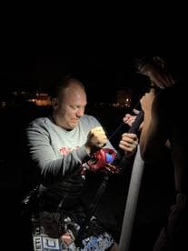 Two anglers preparing their fishing gear at night, showcasing the excitement of night fishing.