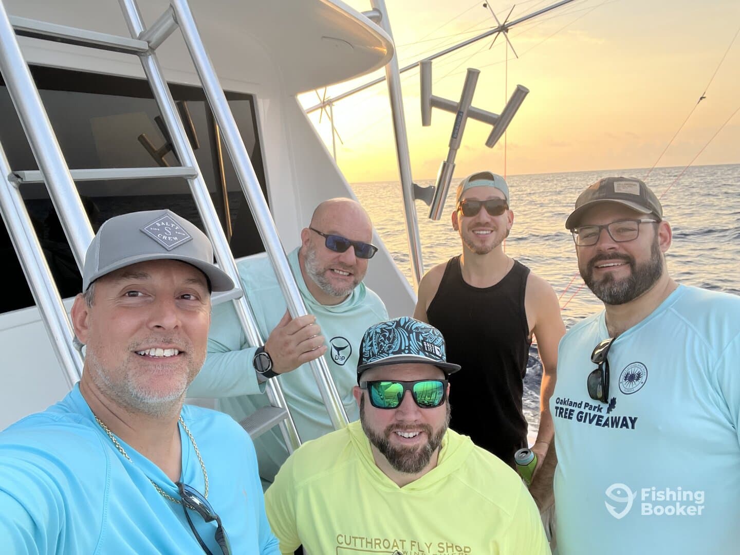 Group of friends enjoying a fishing trip on a boat during sunset, showcasing camaraderie and a relaxed atmosphere.