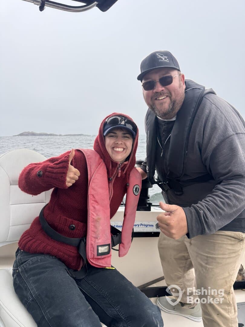 Two anglers enjoying their time on a boat, showcasing a friendly atmosphere while preparing for a fishing adventure.