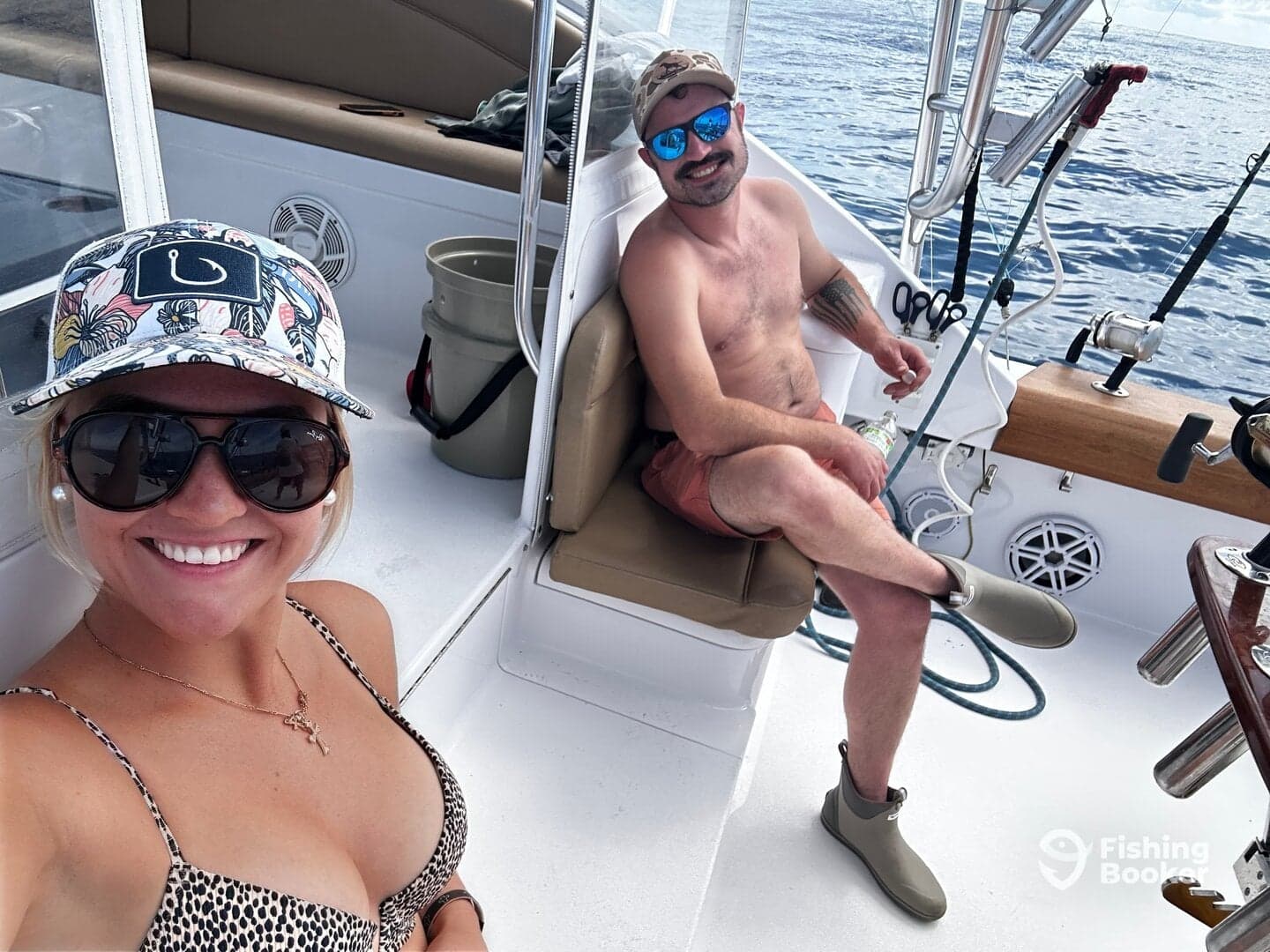 Two anglers relaxing inside the boat, showcasing the comfortable seating and interior setup while enjoying a day on the water.