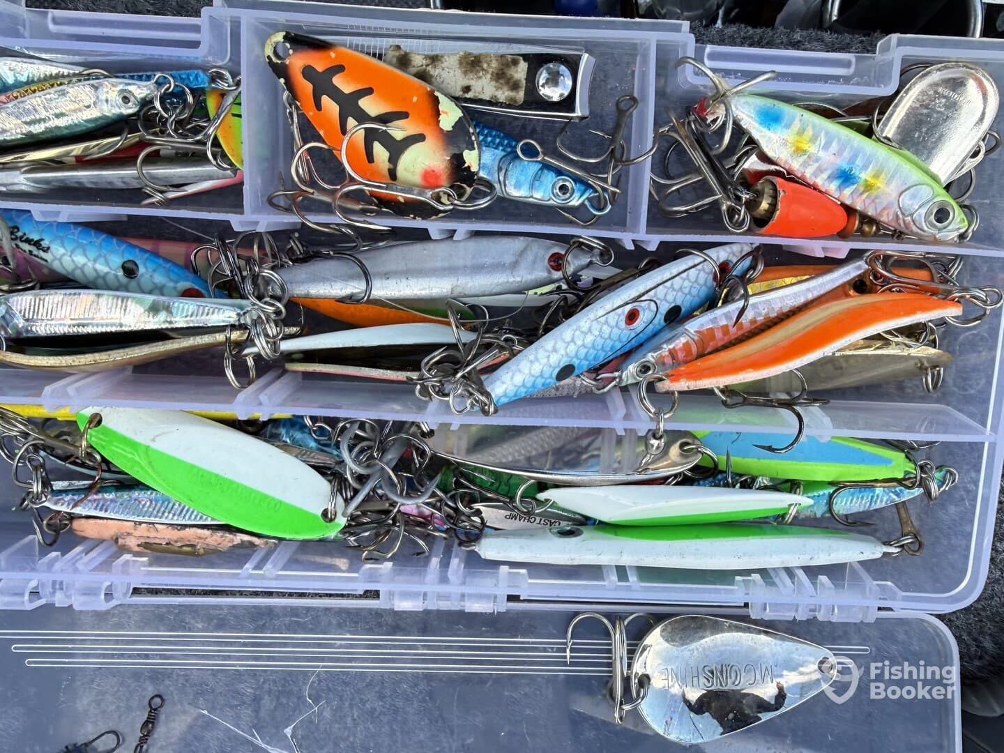 A close-up view of a tackle box filled with various fishing lures, showcasing a colorful assortment ideal for different fishing conditions.