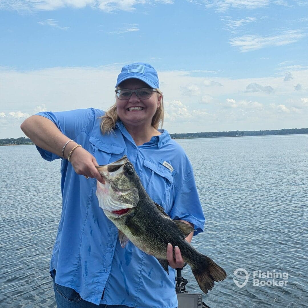 A proud angler displaying a large Largemouth Bass while enjoying a day on the water.