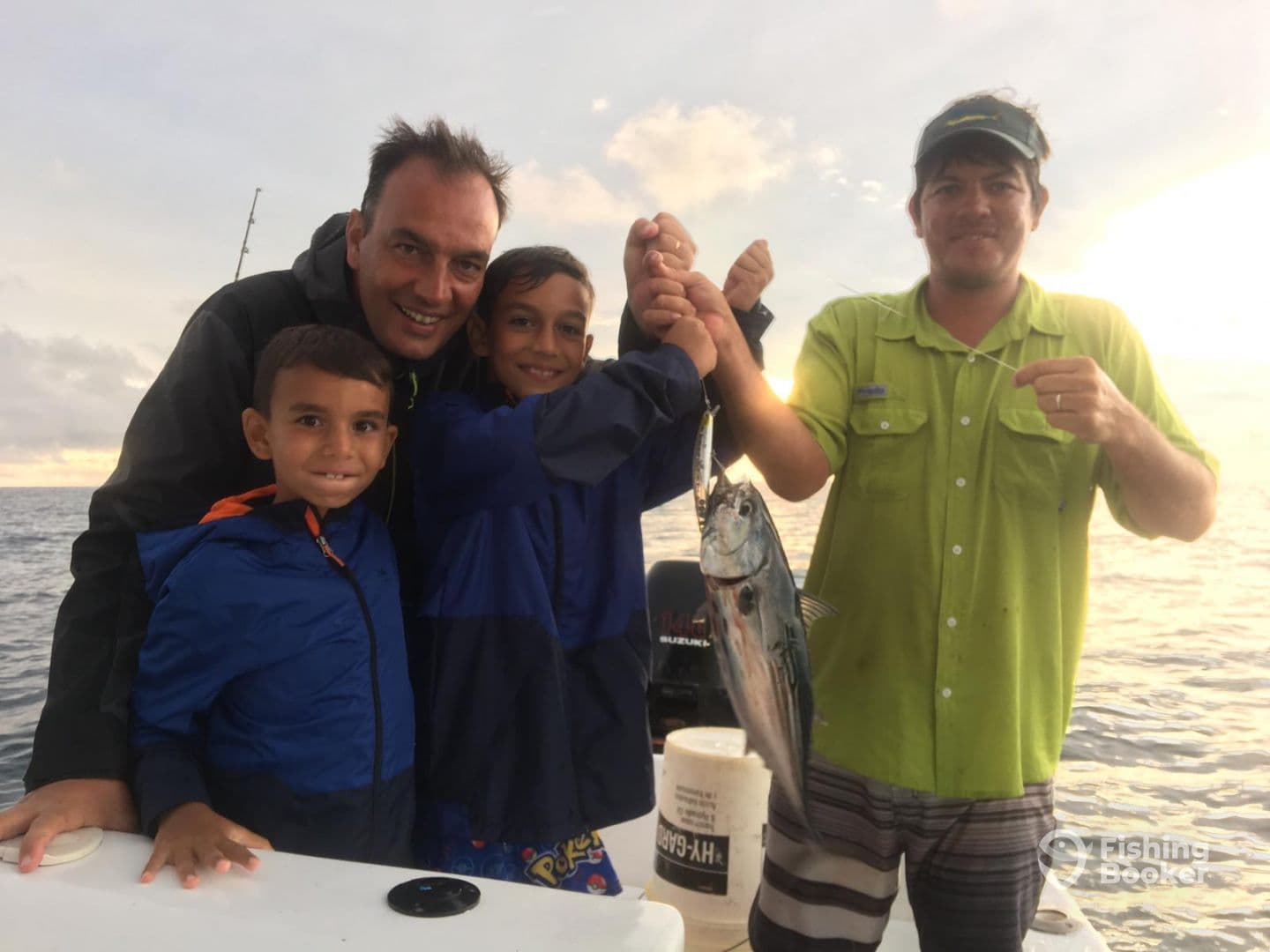 A family enjoying a fishing trip, proudly displaying a caught fish on a boat, showcasing a memorable moment together.
