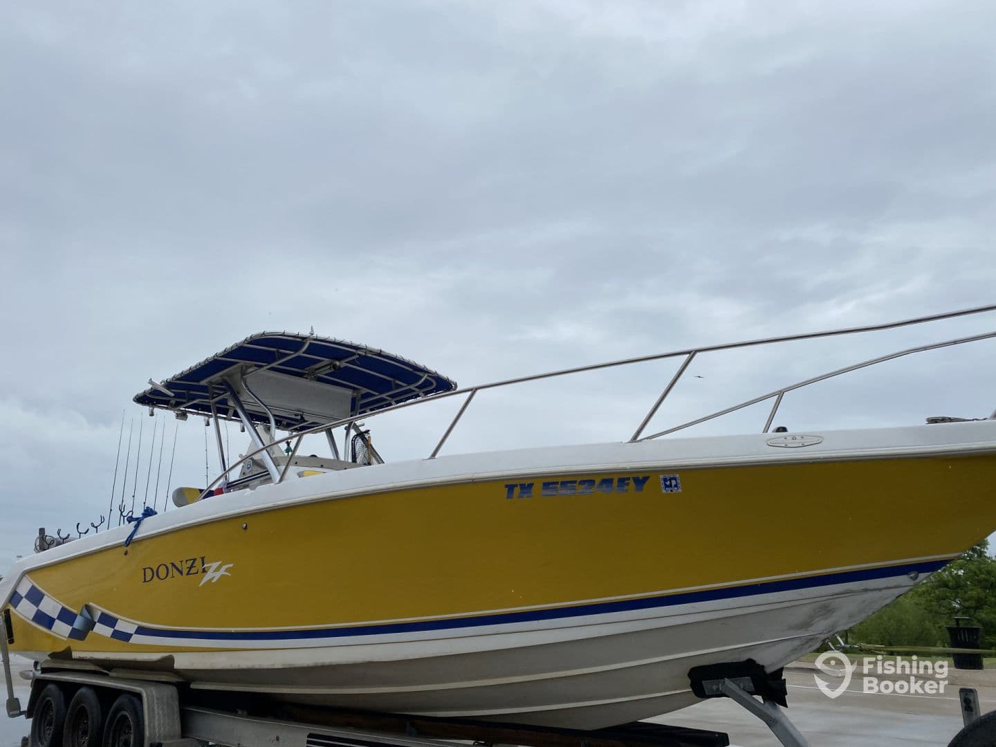 A vibrant yellow Donzi boat with a T-top, showcasing fishing rods and ready for a day on the water.