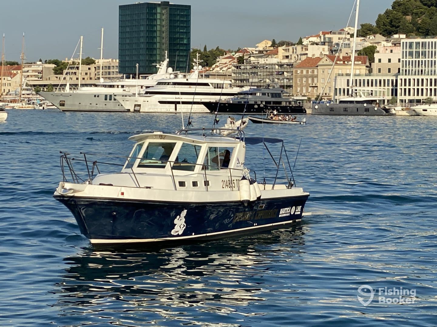A sleek fishing boat cruising in a vibrant harbor, surrounded by luxury yachts and coastal buildings.
