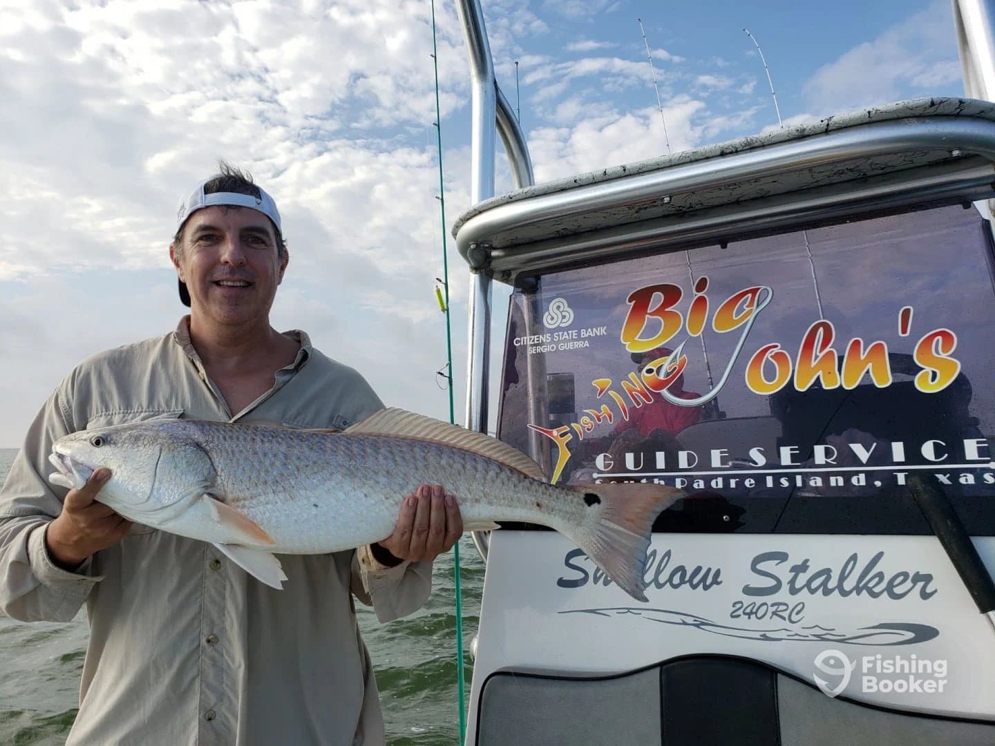 An angler proudly displaying a large Redfish while aboard the 'Swallow Stalker' near South Padre Island, Texas.