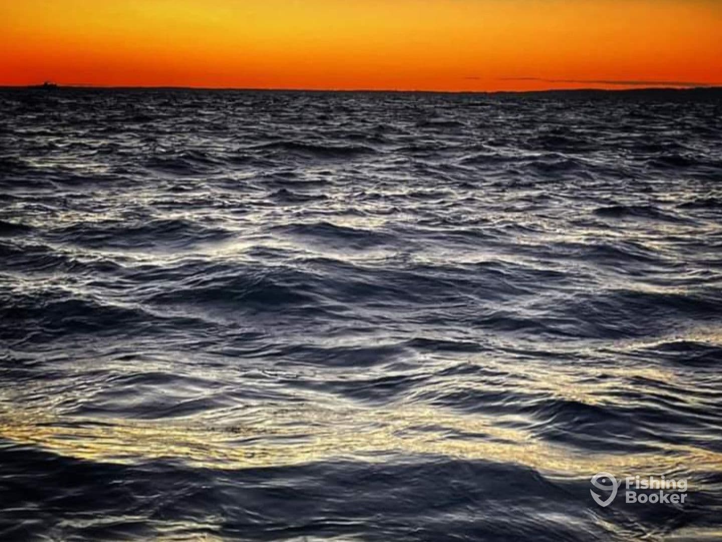 A serene sunset over the ocean, showcasing the calm waters and vibrant colors of the sky.