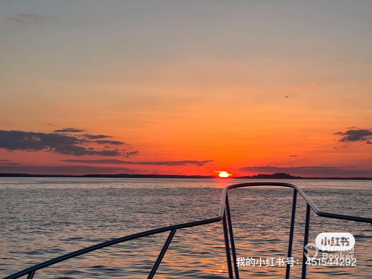 A stunning sunset view from the bow of a boat, showcasing the tranquil waters and distant islands, perfect for evening fishing adventures.
