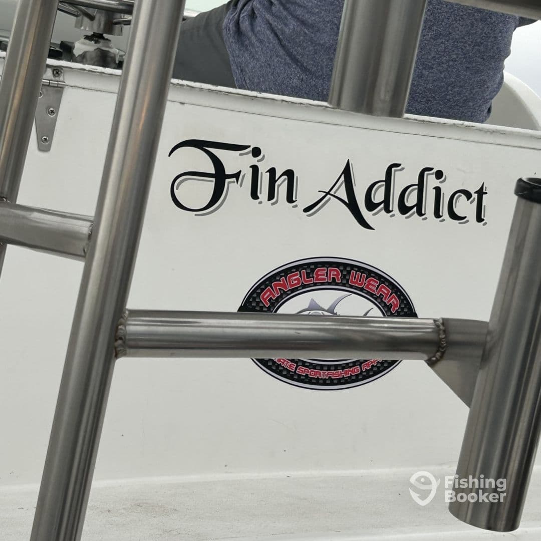Interior view of the 'Fin Addict' boat showcasing seating and branding, ideal for fishing enthusiasts.