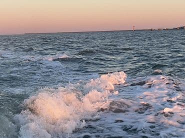 A scenic view of ocean waves at sunset, capturing the tranquil beauty of the fishing environment.