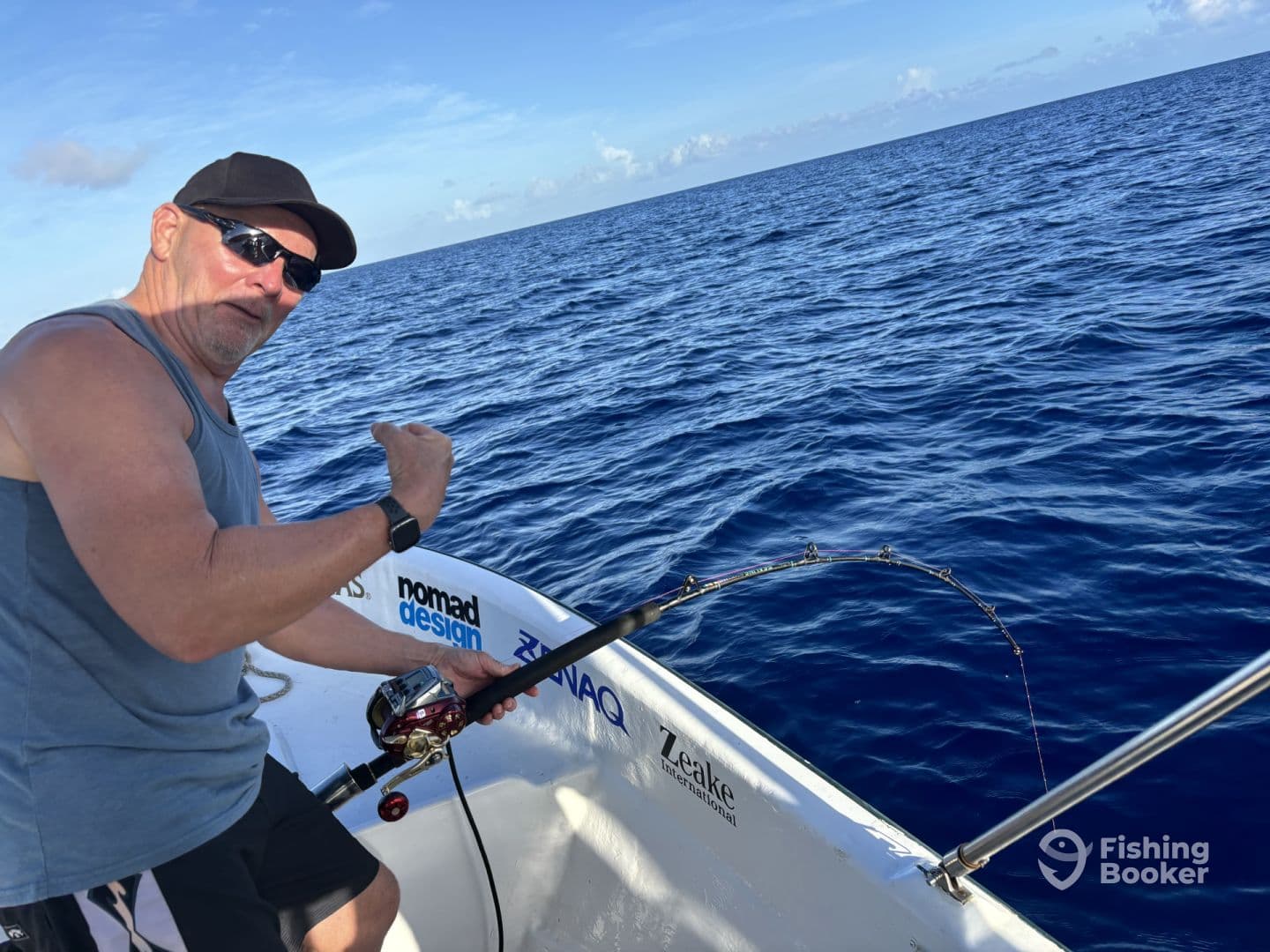 An angler actively reeling in a catch while fishing on a boat in deep blue waters, showcasing the excitement of the sport.