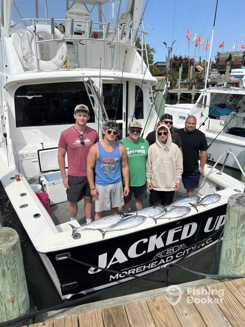 A group of anglers proudly posing with their catch of several Mahi Mahi on the back of the 'Jacked Up' charter boat in Morehead City.