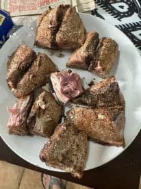 A plate of freshly cooked fish fillets, showcasing a variety of cuts, likely prepared after a successful fishing trip.