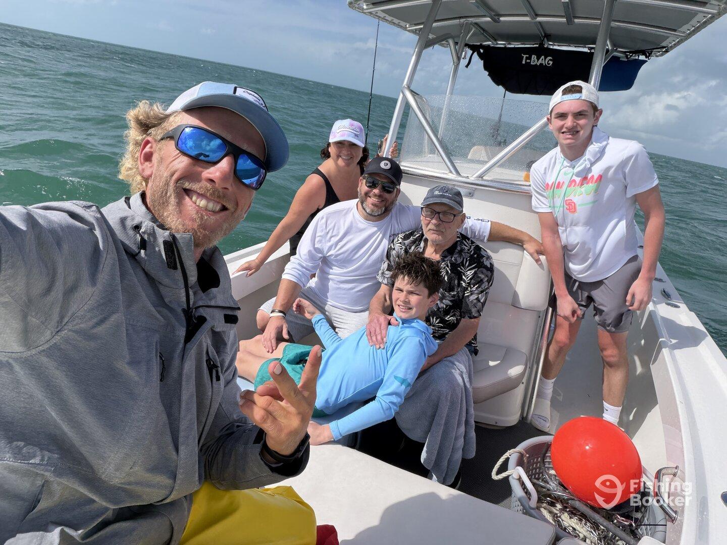 A cheerful family enjoying their time on a fishing boat, capturing a fun moment together on the water.