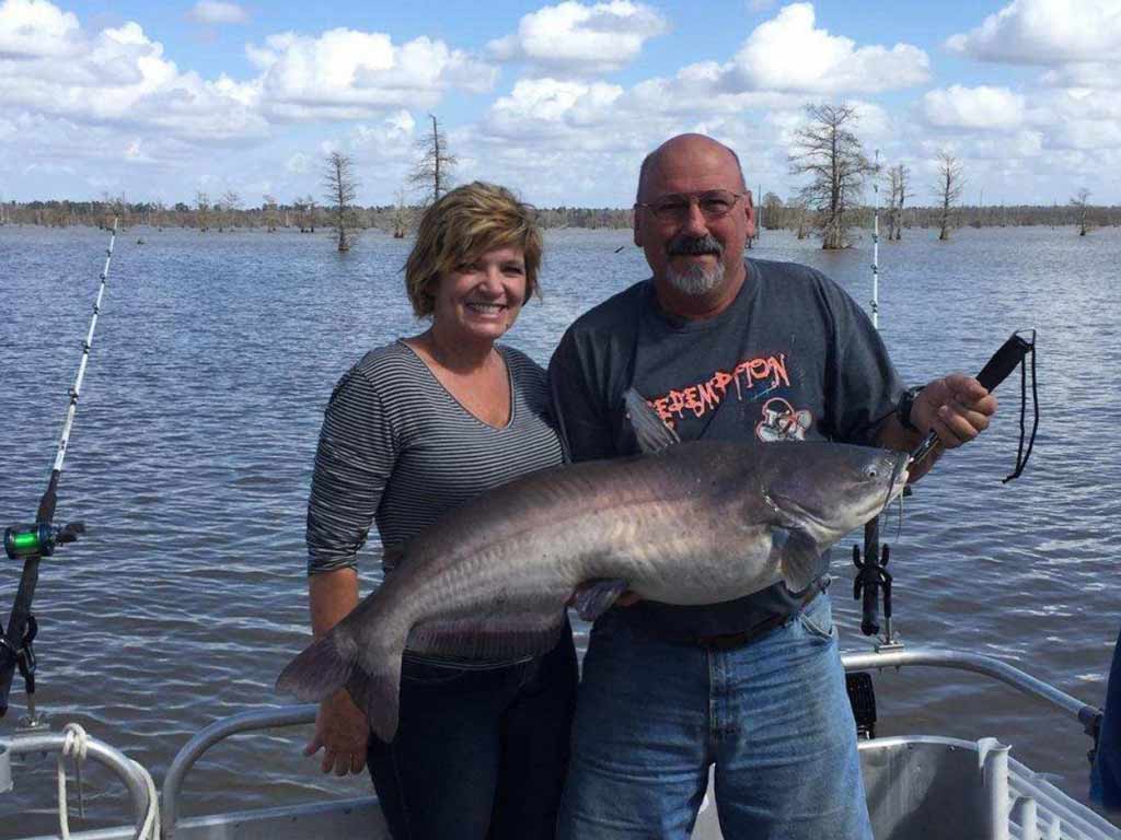 A photo showing two happy anglers with their Catfish caught while fishing on Santee Cooper lakes