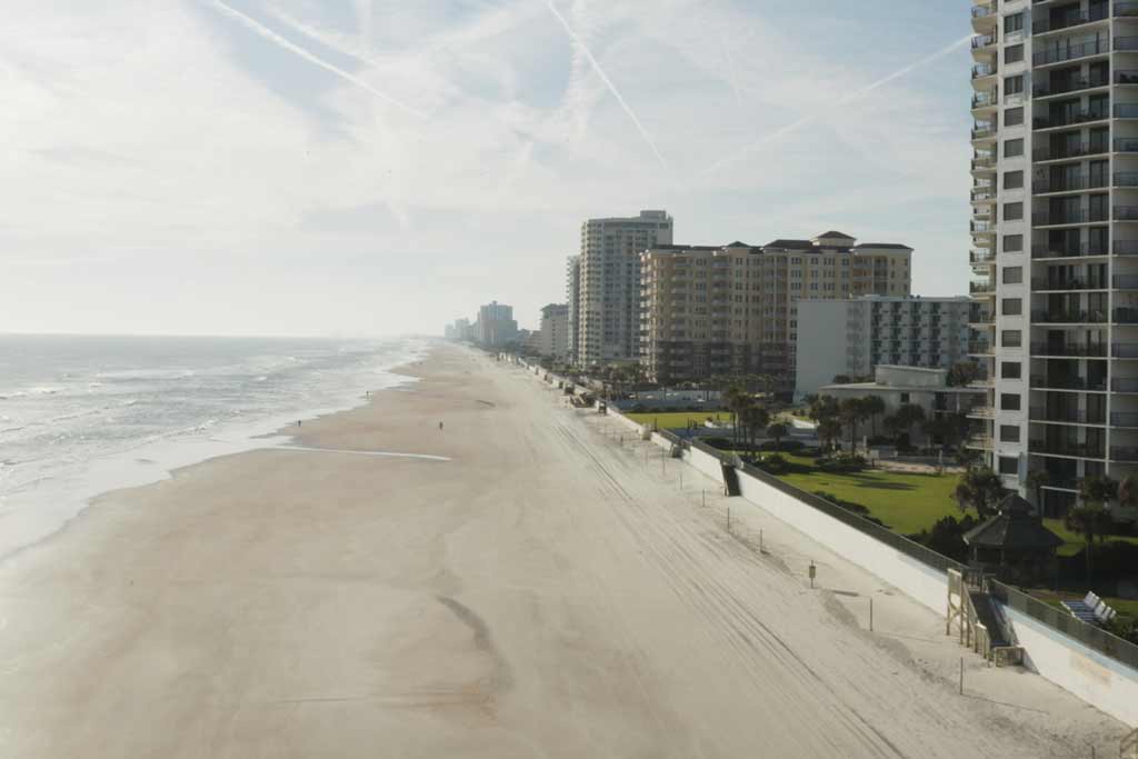 An aerial view of the beach, sea, and buildings in Daytona beach, one of the top fishing spots in Florida.