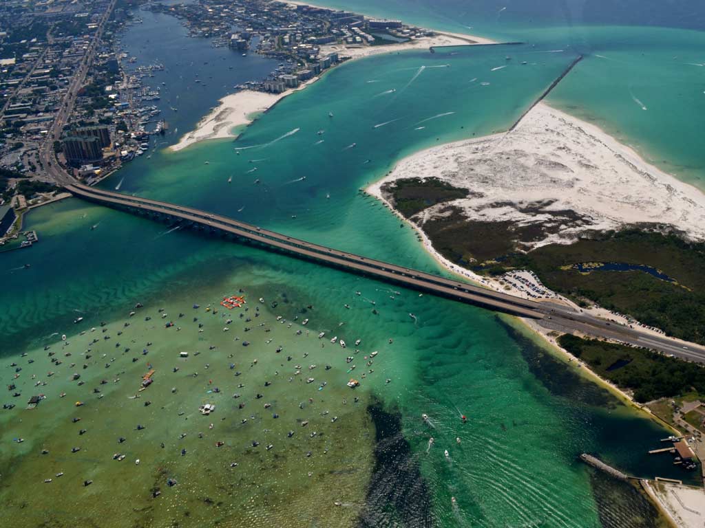 An aerial view of the harbor in Destin, Florida, showing the East Pass, the Marler Bridge, and the Crab Island