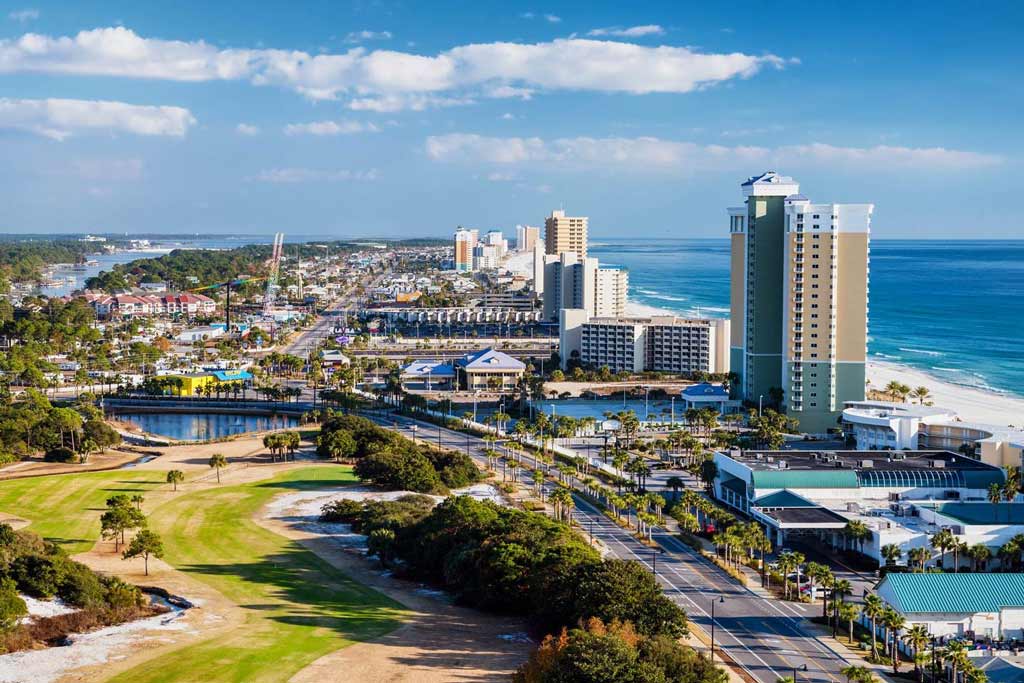 An aerial view of Panama City Beach downtown with buildings, canals, and a beach