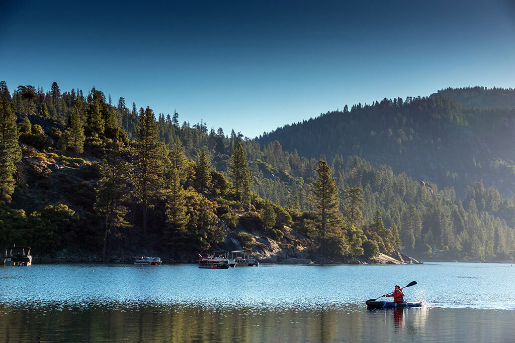 A man kayaking on a Lake Tuolumne County, CA