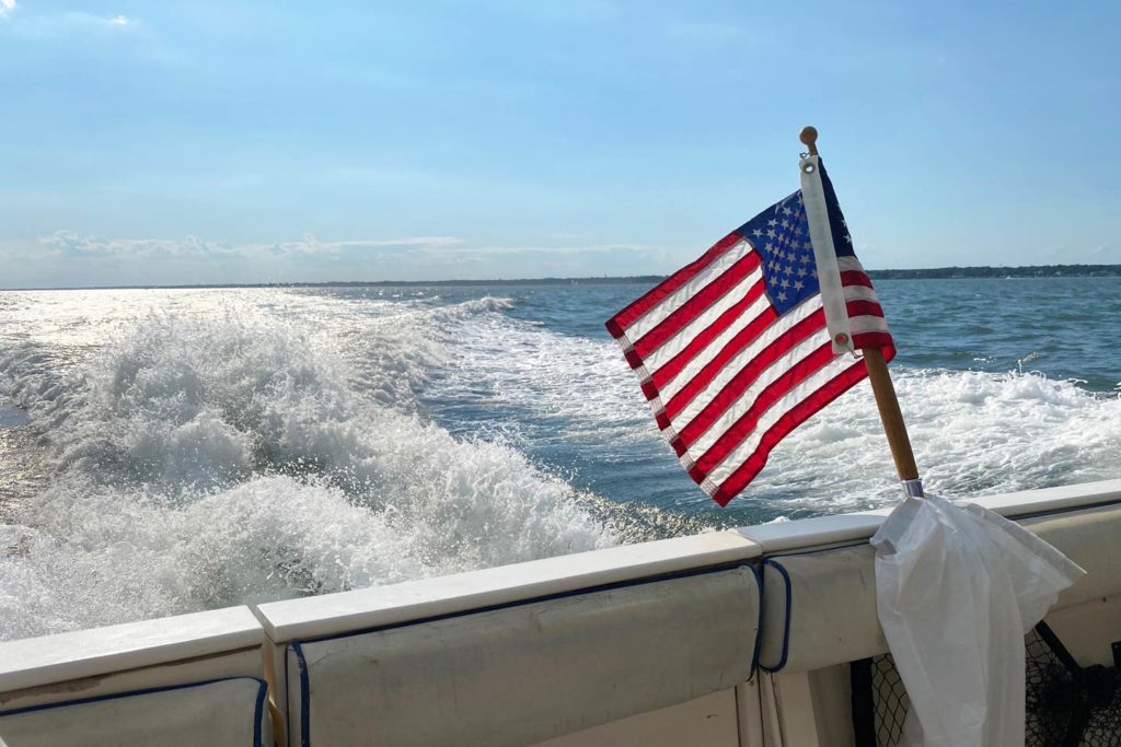 An American flag on the back of a boat.