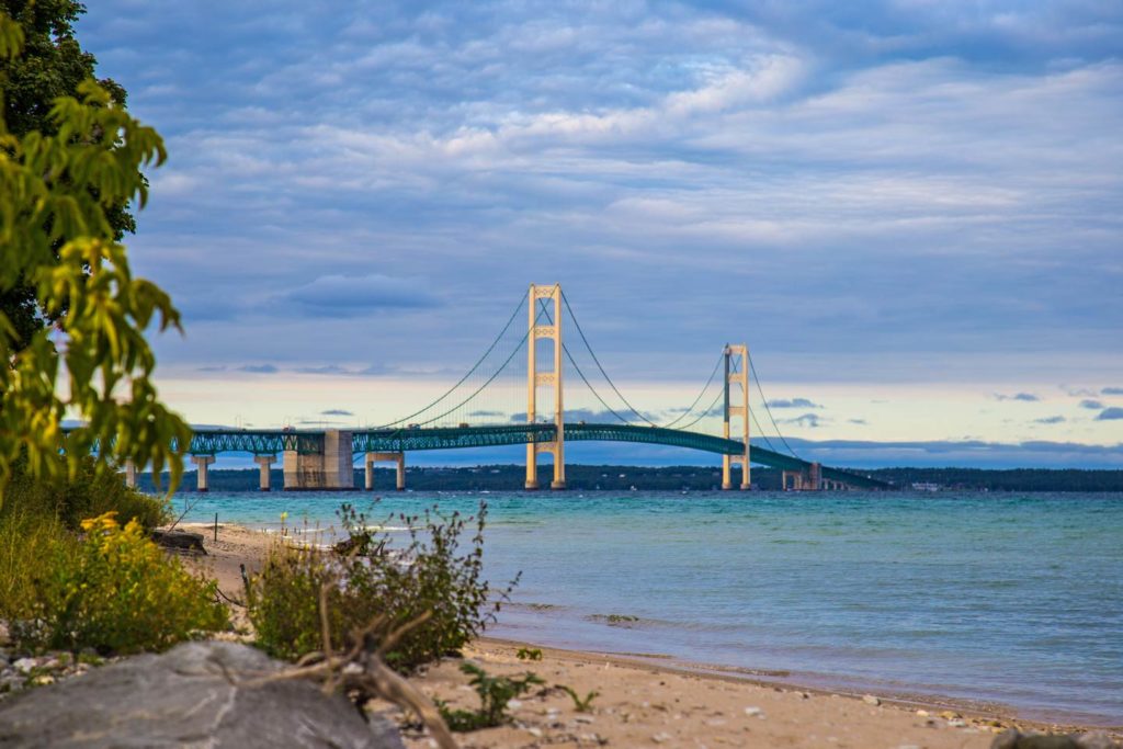 The mighty Mackinac Bridge spanning the Straits of Mackinac, taken from the beach in Mackinaw City in late summer.