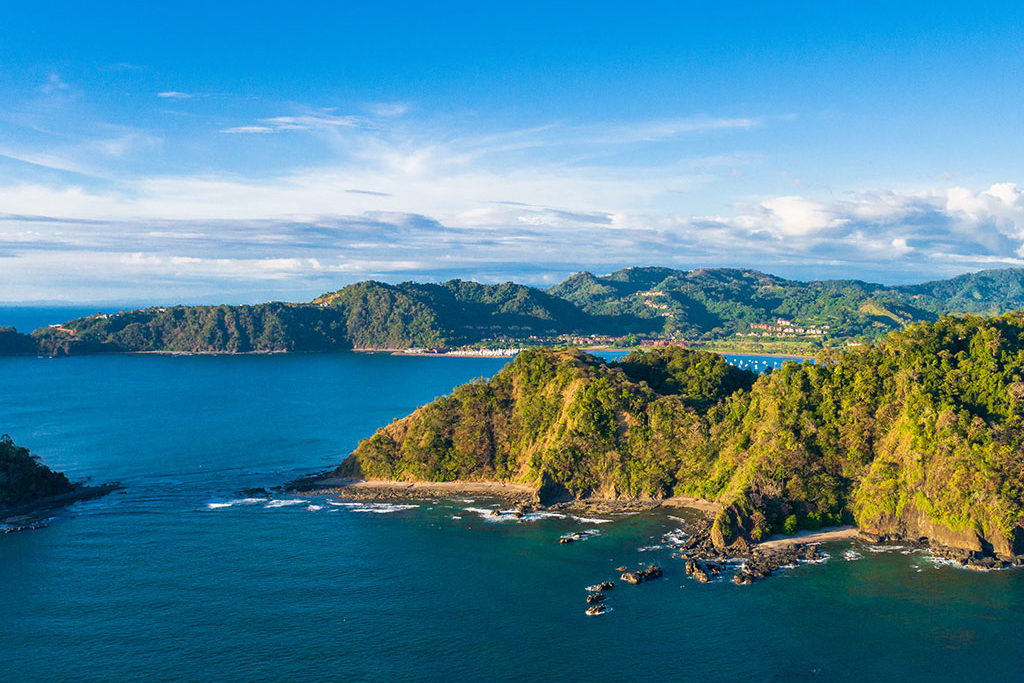 A view of the Costa Rica coastline with green mountains and blue seas
