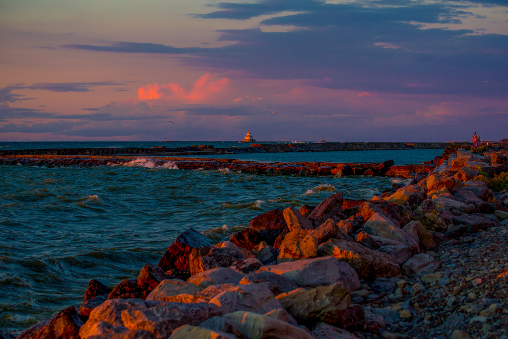 A view of the sun setting over the lighthouse in Oswego