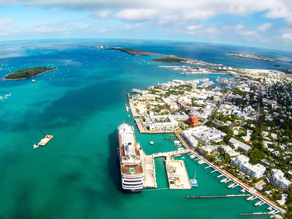 An aerial view of Key West with a cruise ship docked in the arbor at the bottom of the picture